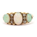 An opal and diamond ring, the three slightly graduated oval opals, interspaced with thre small old