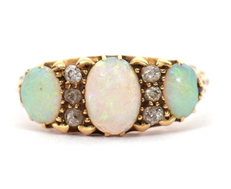 An opal and diamond ring, the three slightly graduated oval opals, interspaced with thre small old mine cut diamonds to each 