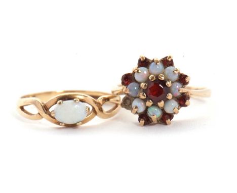 Two 9ct opal rings: to include a 9ct opal and garnet cluster ring, size K, 3.3g, and a 9ct oval opal cabochon ring, wtih cros