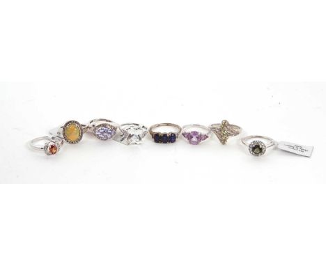 Eight silver and gemset rings: to include an opal cabochon and diamond highlight ring, size N, together with others including