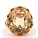 A citrine ring, the oval mixed cut citrine, approx. 16mm long, claw mounted with looped gallery,