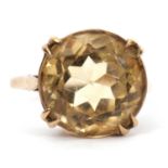 A 9ct citrine ring, the round faceted citirine, in four double claws with plain band hallmarked