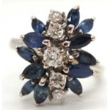 An 18k sapphire and diamond ring, set with a line of five round brilliant cut diamonds and a spray