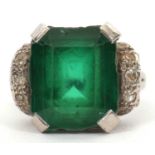 A green stone and diamond ring, the emerald cut green stone (possibly an emerald doublet) in a