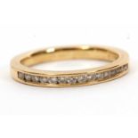 An 18ct diamond half hoop ring, channel set with small round brilliant cut diamonds, total 0.