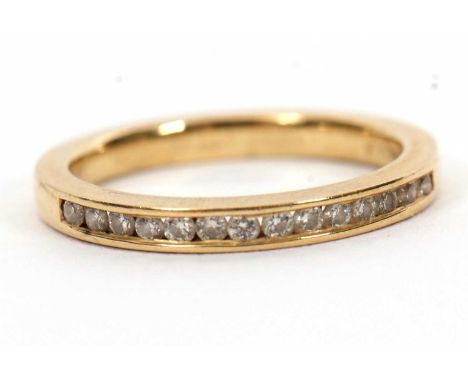An 18ct diamond half hoop ring, channel set with small round brilliant cut diamonds, total 0.20cts, with plain band stamped 7