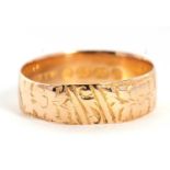 A late Victorian 18ct gold ring, with chased floral decoration, 6mm wide, hallmarked Birmingham