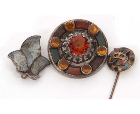 Three agate brooches: to include an agate stick pin with crown motif, cased; an oval agate and paste glass and a banded agate
