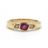 A 9ct ruby and diamond ring, the round collet mounted ruby with a round brilliant cut diamond to