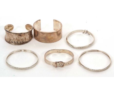 A quantity of silver bangles, to include a hinged adjustable buckle bangle stamped 925; a 3cm wide open ended silver bangle s