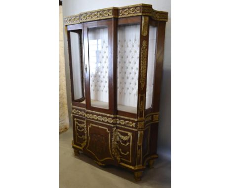 A French Kingwood Marquetry Inlaid and Gilt Metal Mounted Display Cabinet with a central glazed door enclosing a glass shelf 