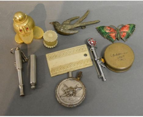 An Acme Whistle, together with a collection of other items to include a Lighter, two Bone Sewing Implements, three Brooches a
