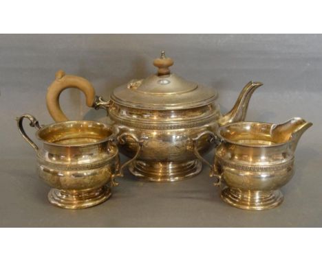 A George VI Silver Three Piece Tea Service, comprising teapot, cream jug and two handled sucrier of circular form, Birmingham