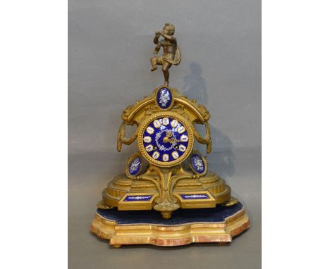 A 19th Century French Spelter and Porcelain Mounted Mantle Clock, the dial with Roman numerals and with figural surmount upon