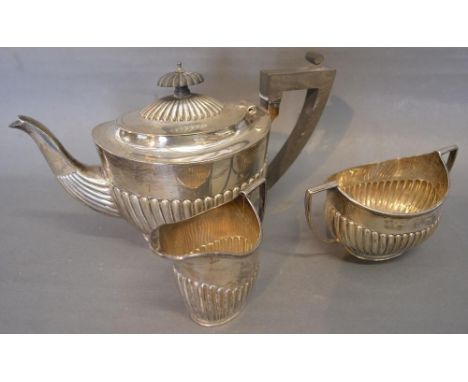 An Edwardian Silver Three Piece Tea Service of Half Lobed Form comprising teapot, cream jug and two handled sucrier, London 1