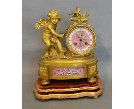 A 19th Century French Ormolu and Porcelain Mantle Clock, the drum clock with porcelain panel hand painted with putti and with