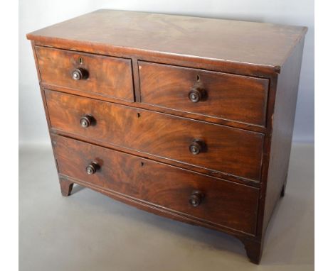 A 19th Century Mahogany Straight Front Chest of Small Proportions, with two short and two long drawers with knob handles rais