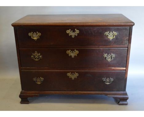 A George III Mahogany Chest of three long drawers with brass handles and escutcheons raised upon bracket feet, 95cms wide 