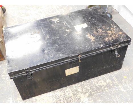 A black painted metal trunk, bearing various labels, 36cm high, 91cm wide, 55cm deep.