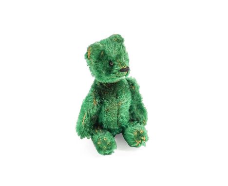 An Early 20th Century Green Plush Schuco Teddy Bear with a hinged body enclosing compact and lipstick, black button eyes, sti