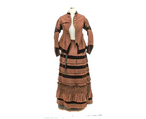 A Circa 1880 Brown Silk Two-Piece comprising a fitted jacket with a round neck collar mounted with velvet and trimmed with si