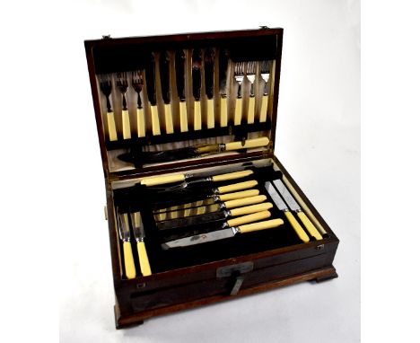 A 1930s oak canteen of cutlery containing bone-handled and Old English pattern silver plated cutlery for six place settings (