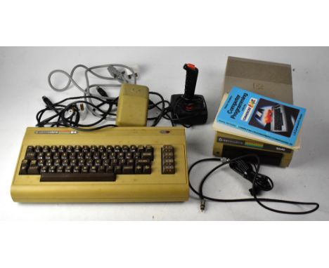 A Commodore 64 personal computer with powerbank, 154I disc reader, Pointmaster joystick, and Easy Script instruction manual.