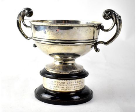 A George V hallmarked silver trophy with scrolling handles, Walker &amp; Hall, Sheffield 1924, on a wood and hallmarked silve