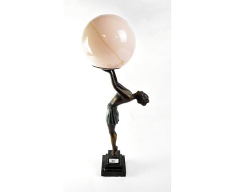 An Art Deco style bronzed spelter figural table modelled as a young lady arching her back and holding aloft a peach-tinted gl