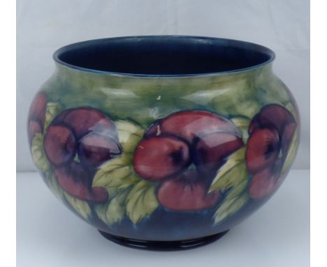 WILLIAM MOORCROFT; a large pottery jardinière decorated with repeating pansies and leaf pattern, on a green and graduated blu