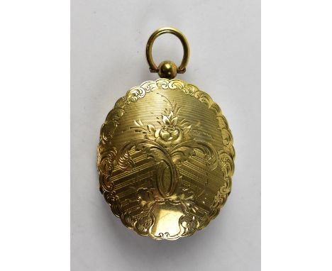 A Victorian silver gilt double oval locket with engine turned pattern, floral detail front and back, the front shows a painte