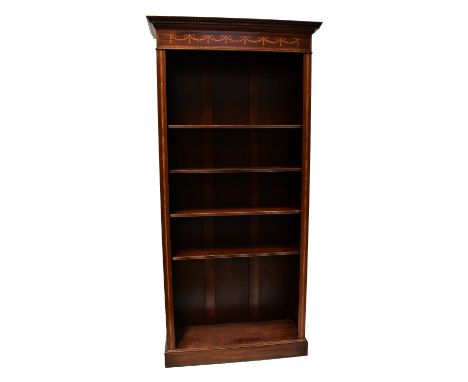 A pair of reproduction Edwardian freestanding open bookcases, the dentil moulded cornice above inlaid frieze and five adjusta