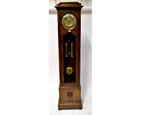 An early 20th century oak cased thirty hour chiming longcase clock, shaped pediment above circular silvered dial set with Ara