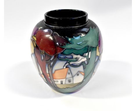 MOORCROFT; a trial piece vase in the Art Nouveau manner, decorated with cottages amongst coloured trees, on a blue ground, gr