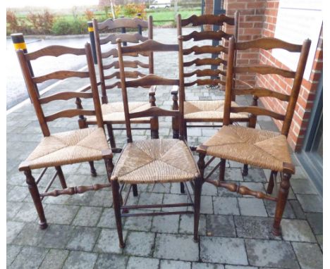 A harlequin set of five 20th century ladder back rush seated chairs comprising a pair of six rung back Lancashire carvers, ru