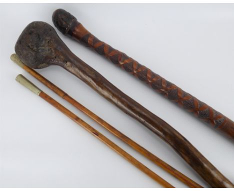 A carved bamboo walking cane, length 90cm, two bamboo swagger sticks and a primitive root knobkerrie stick with later added s