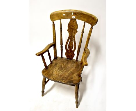 A 19th century elm stick back open armchair with vase-shaped splat, on turned legs united by an H-stretcher, height 112cm.