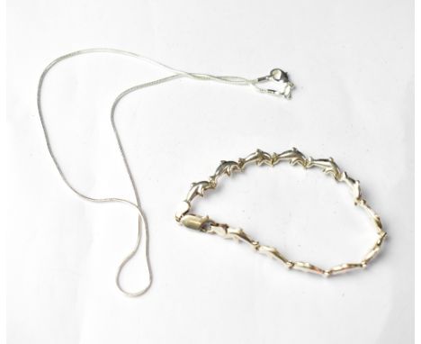 A sterling silver dolphin-form bracelet and a sterling silver necklace (2). 