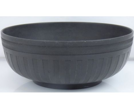WEDGWOOD; a 19th century black basalt bowl with engine turned border and fluted design body, 10.5 x 26cm.