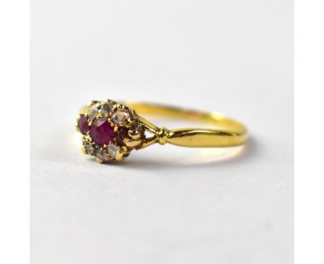 An 18ct gold ring set with diamond and ruby, size O, approx 2g.