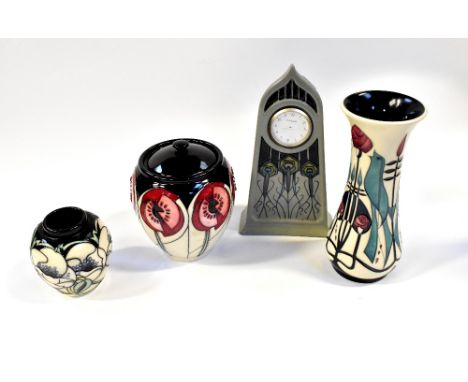 MOORCROFT; four Art Nouveau and Secessionist inspired pieces, comprising a clock with peacock feathers, a Mackintosh-style va