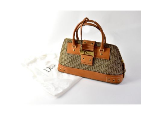 CHRISTIAN DIOR; a 'Diorissimo' brown canvas bag with leather trim, yellow metal hard wear and clasp with Dior logo, 19 x 38cm