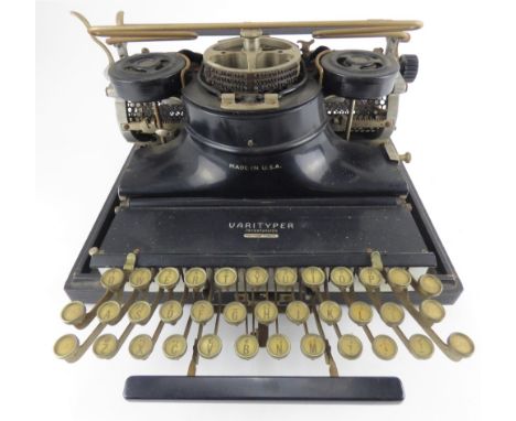 VARITYPER; a vintage 1930s American typewriter, together with a spare Tepe plate typeface, boxed.