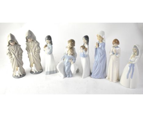 NAO; eight figures of children at bedtime, to include two boys in dressing gowns with puppy, young girl with little sister an