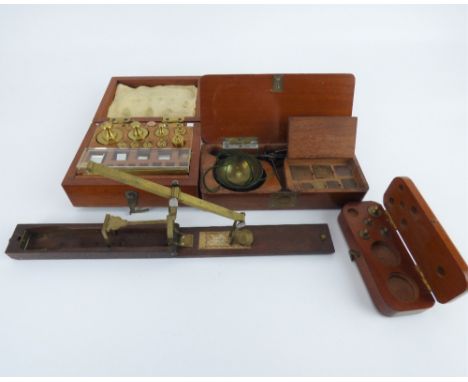 A virtually complete set of brass postal scales, in mahogany box with tweezers, a pocket balance scale with a selection of sq