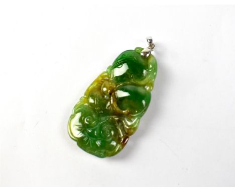 A spinach and multicoloured green jade pendant of abstract form, length 4.5cm.