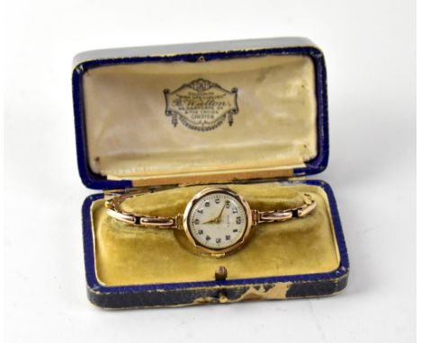 ROLEX; a 9ct gold wristwatch, the circular dial set with Arabic numerals, manual movement, case stamped '375', on an expandin