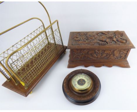A Black Forest style carved wooden jewellery box with leaves and berries, the lid enclosing a six-section tray with void unde