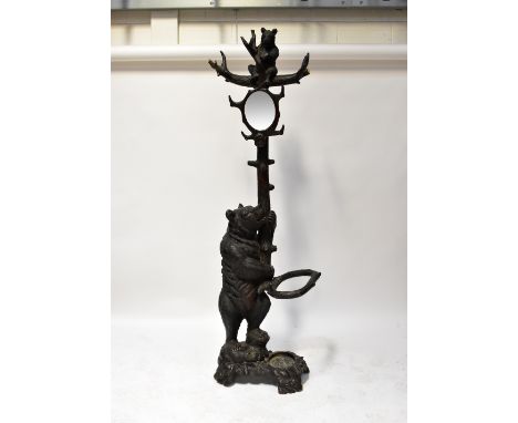A 19th century Black Forest carved stick stand in the form of a tree with a bear raised on back paws with bear cub seated on 