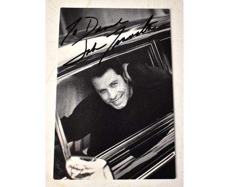 JOHN TRAVOLTA; a black and white photograph bearing his signature.We have not authenticated this signature, please satisfy yo